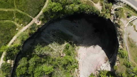 Aerial top down shot of Devil's Punch Bowl, a 37-metre ribbon waterfall on Stock Footage 154982066