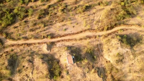Aerial top-down shot of dusty rural vill... | Stock Video | Pond5