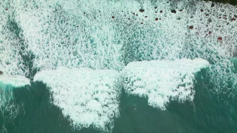 Aerial top down shot of foamy waves reac... | Stock Video | Pond5