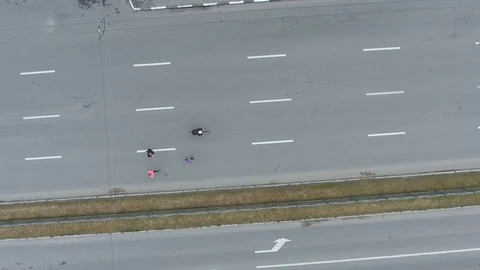 Aerial top down shot of group of runners and cyclist at marathon on city road Stock Footage 105179810