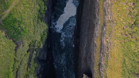 Aerial Top-Down Shot of Ocean Waves Rushing Through Rocky Cliffs at Loop Head Stock Footage 345685950