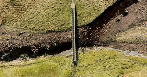 Aerial top down shot of pedestrian crossing a footbridge Stock Footage 331504753