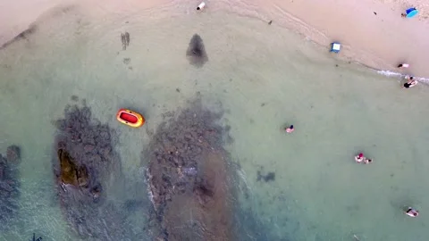 Aerial top down shot of people relaxing at the beach and an empty Stock Footage 140257554
