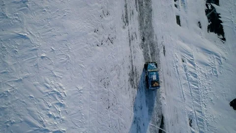 Aerial top down shot of an off-roader all-terrain vehicle SUV drives on snow and Video stock 167929490