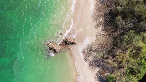 Aerial top down shot of a rock in a beac... | Stock Video | Pond5