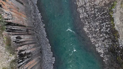 Aerial top-down shot of Stuðlagil Canyon and river framed by basalt columns Video stock 279664810