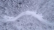 Aerial - Top Down Shot Of Two People Ski Walking On Snowy Road Stock Footage