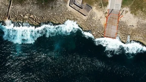 Aerial Top Down Shot of Waves hitting the Shore Stock Footage 102909978