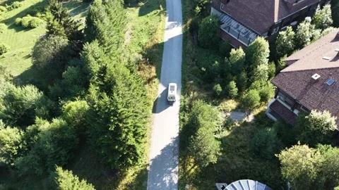 Aerial Top Down Shot of White Camper Van Driving along Mountain Forest Road 库存影片 343839126