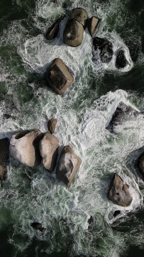 Aerial top down slow motion View of Rushing River Waters Cascading Over Rocks in Stock Footage 270611359