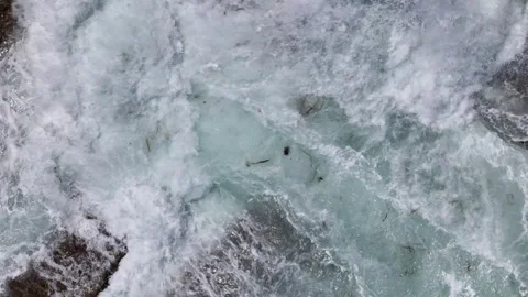 Aerial top down slow motion View of Waves Crashing on Rocks in the Ocean Stock Footage 279572470