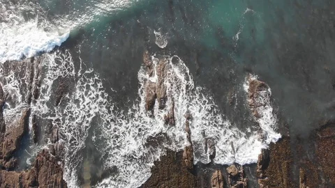 Aerial top down spiral view of water sea and rocks Video stock 106425924