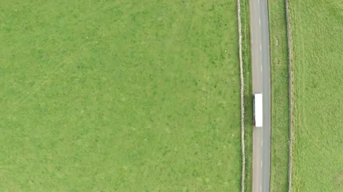 Aerial top down static shot of a rural road with passing cars and trucks Stock Footage 140448690