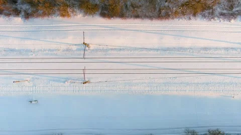 Aerial top-down sunset view of a railroad among pine forests at winter. 스톡 동영상 258912419