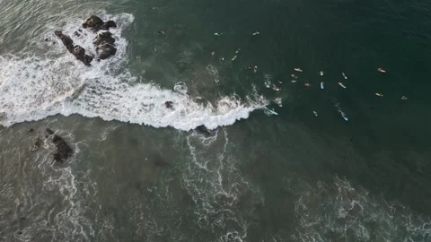 Aerial top down of surfer gathering in ocean water sea waiting for perfect waves Video stock 259062416