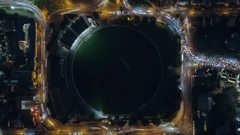 Aerial top down time lapse, traffic traveling around cricket field. Stock Footage 92661066