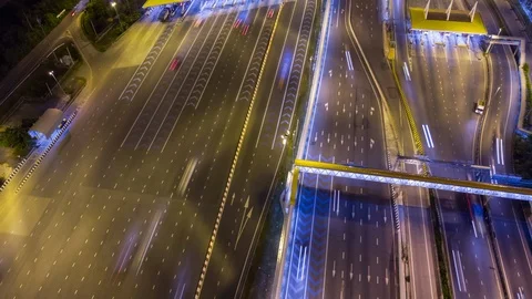 Aerial top down time lapse over expressway toll gate with many vehicles passing. Stock Footage 109062515