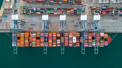 Aerial top down time lapse view of large container cargo ship being unloaded Video stock 261401985