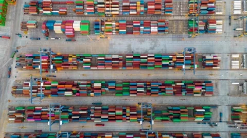 Aerial top down time lapse view of rows of cargo containers and trucks Video stock 261402112