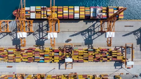 Aerial top down time lapse view of large container cargo ship being unloaded Stock Footage 310832439
