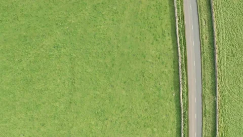 Aerial top down tracking shot of a rural road with passing cars and trucks Stock Footage 140448891