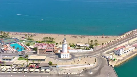 Aerial top down tracking shot of a lighthouse in Malaga, Spain Stock Footage 229016649