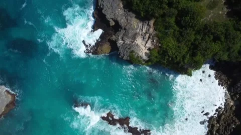 Aerial Top Down Tracking Shot: Blue Lagoon to Nusa Ceningan Cliff Edge Stock Footage 320790032