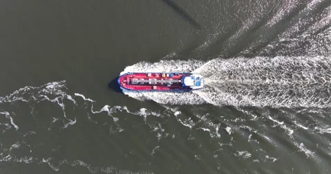 Aerial top down tracking video of industrial ship cruising open ocean sea. Stock Footage 245627044