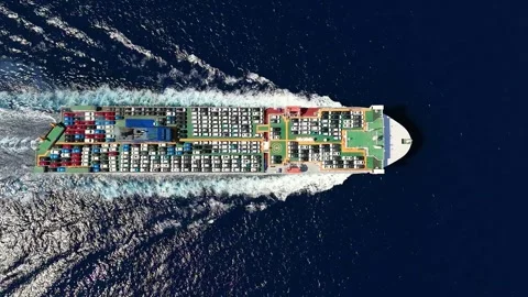 Aerial top down tracking view of a large, industrial car carrier transport ship Video stock 294975457