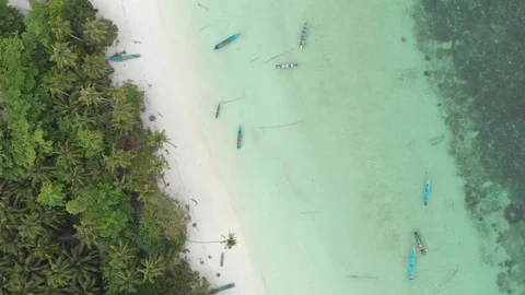 Aerial: top down tropical beach caribbean sea turquoise water with floating boat Stock Footage 109347432