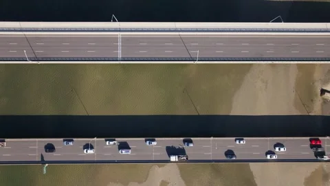 Aerial top down of two parallel bridges tracking cars over low tide 4k drone Stock Footage 253345756