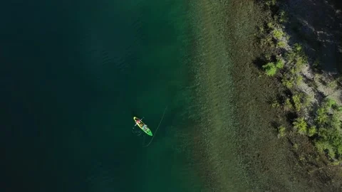Aerial top down of two trained fishers catching trouts with dry fly Stock Footage 144251151