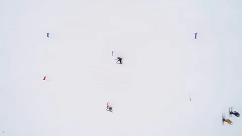 AERIAL TOP DOWN VIEW, 4K. Young ski racers during a slalom competition Stock Footage