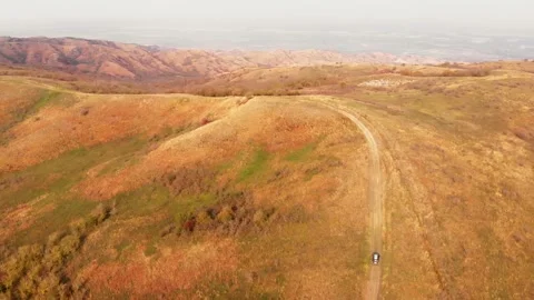 Aerial top down view 4wd vehicle going up the hill with surreal landscape o.. Stock Footage 282788972