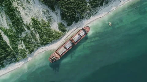 Aerial top down view of abandoned cargo ship. Bulk carrier ran aground after the Stock Footage 208391766