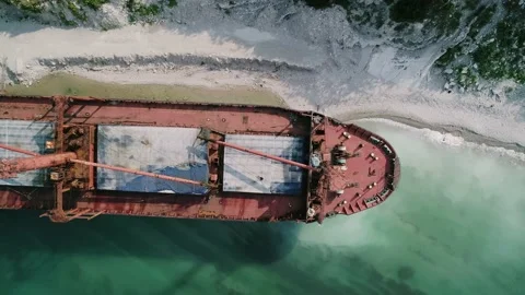 Aerial top down view of abandoned cargo ship. Bulk carrier ran aground after the Stock Footage 223535172