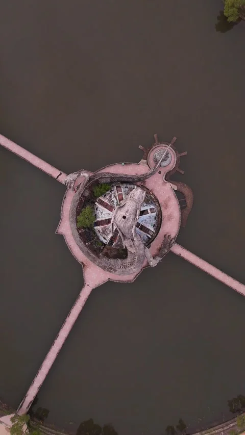 Aerial Top Down View of Abandoned Dragon Sculpture in Lake in Hue, Vietnam Stock Footage 335836417