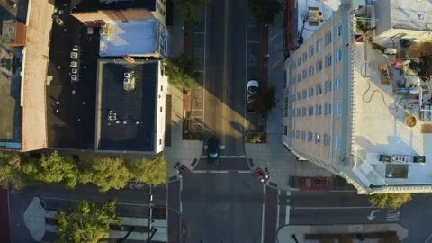 Aerial top down view above a black SUV driving through downtown city 4K Stock Footage 170073410