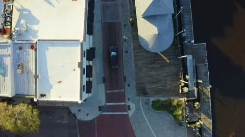 Aerial top down view above a black  SUV driving through downtown Wilmington Stock Footage 170074924