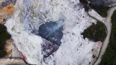 Aerial top down view of an active geothermal mud pool and steaming volcanic Stock Footage 342727195