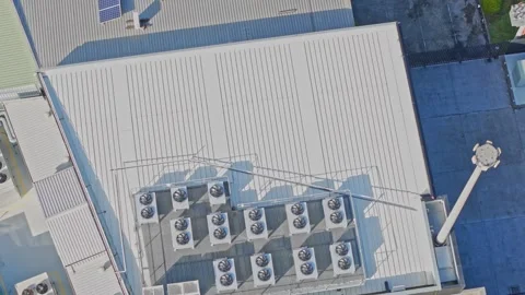 Aerial top down view of air conditioning units on industrial building rooftop Stock Footage 340573135