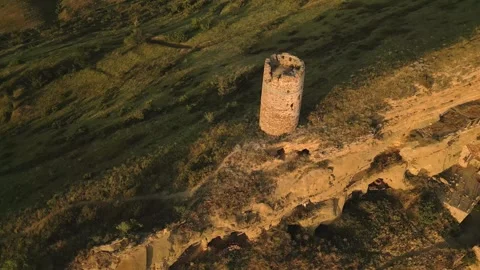 Aerial top down view of an ancient stone watchtower standing alone on a rem.. Stock Footage 312466656