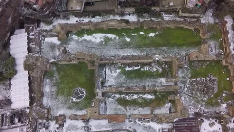Aerial top down view of ancient roman ruins covered in snow Stock Footage 346409858