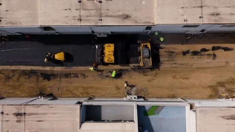 Aerial Top Down View of Asphalt Paving Crew Building Road at Construction Site Stock Footage 341897576