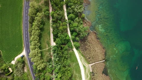 Aerial Top Down view of an athlete rowing on turquoise lake in Banyoles, Spain Stock Footage 332723644
