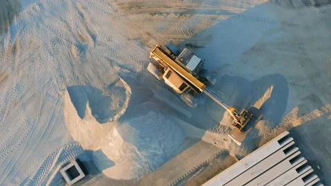 Aerial top down view of the backhoe loader is working on a building plot Stock Footage 166811838