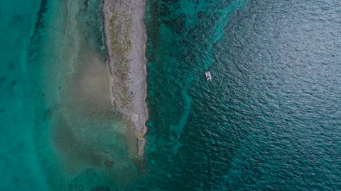 Aerial Top Down View of Bahamas secluded islands and sailboat with clear water Stock Footage 239940930