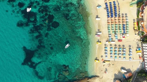 Aerial top down view of the beach, umbrellas and boats Stock Footage 117802119