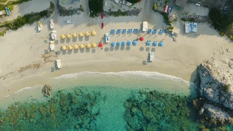 Aerial top down view of the beach, umbrellas and boats Stock Footage 117802133
