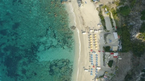 Aerial top down view of the beach, umbrellas and boats Stock Footage 117802144